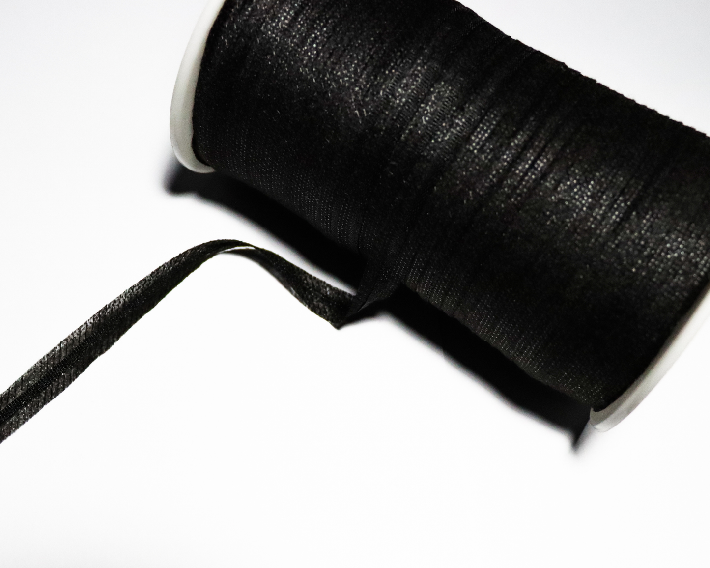 Spool of black color armhole tape on a white background