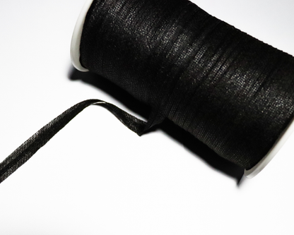 Spool of black color armhole tape on a white background