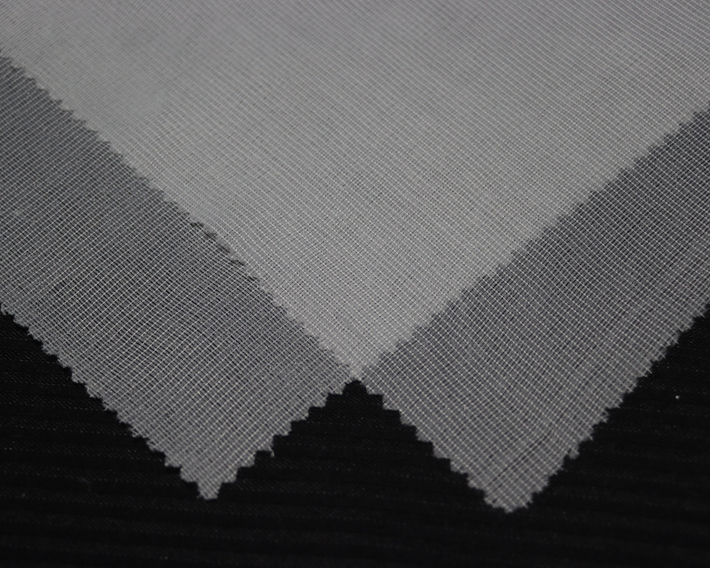 dresses and lightweight jacket interlining sample on black background