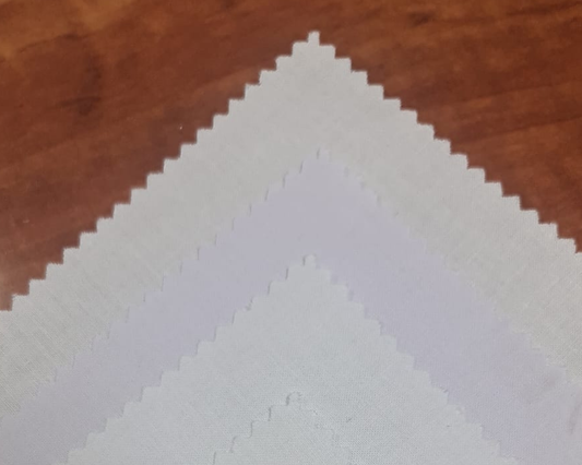 Fabric swatch pyramid with white placket interlining on wooden background