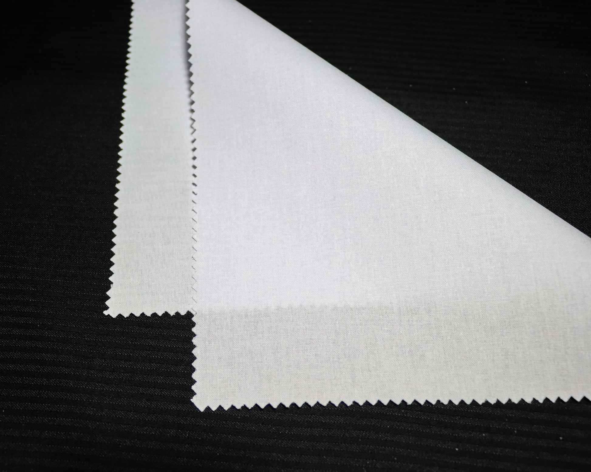 Close-up !F9303 Arabic Thobe interlining on a black background