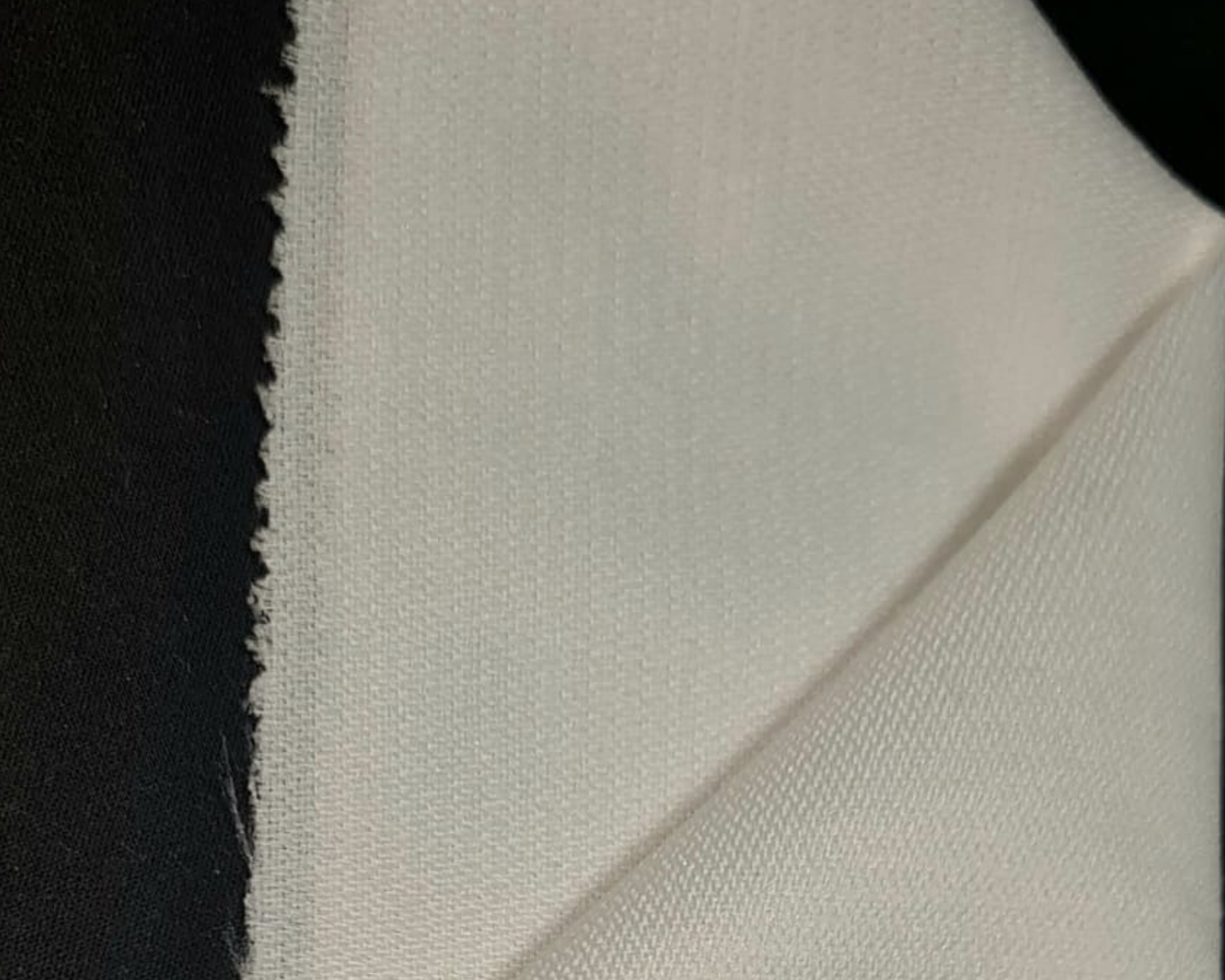 biege color sample of jacket interlining on black background