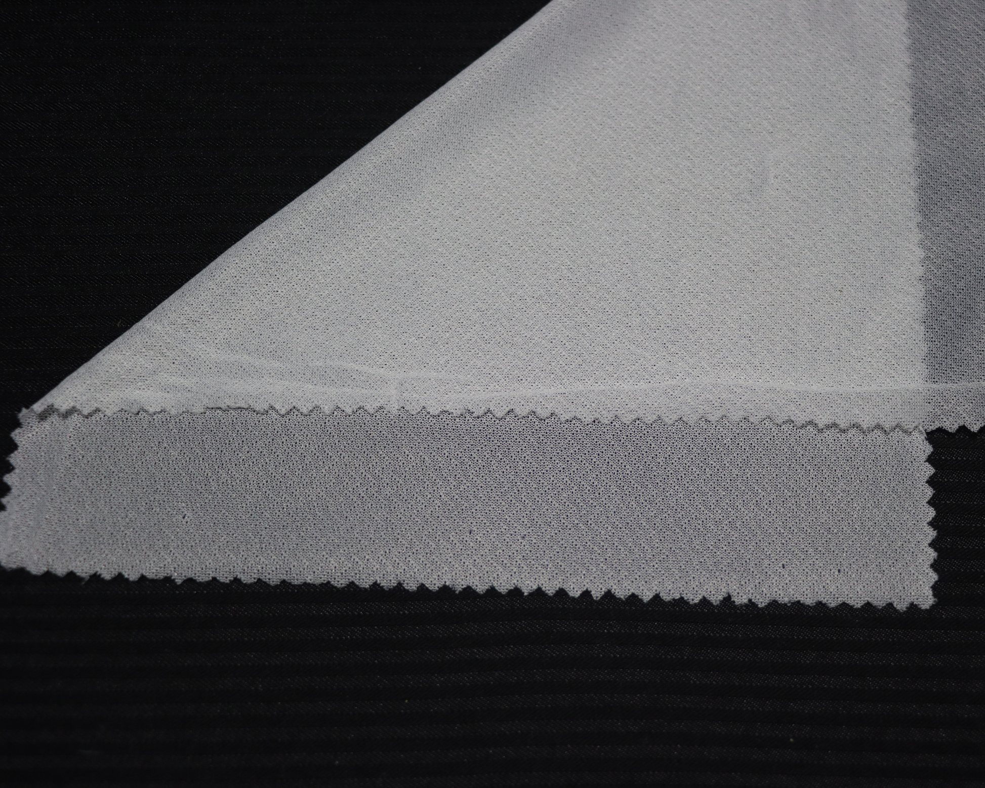 sample of 4-way stretch interlining on black background